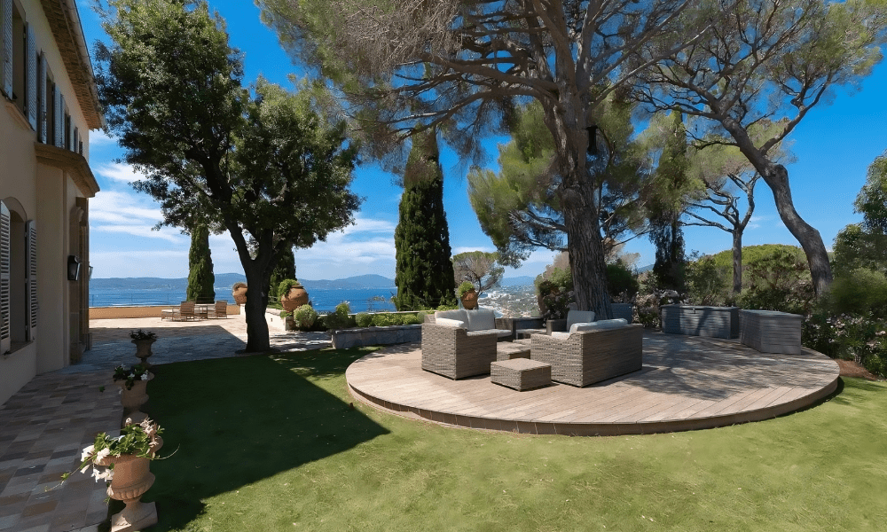 Poolside sunbeds under shaded cabana with sea views